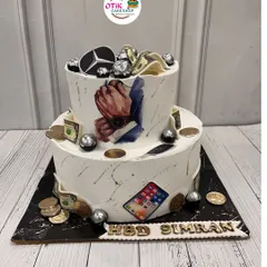 This cake is all about celebrating someone's favorite things. We incorporated edible prints of a luxury car, an iPhone, and money for a truly personalized birthday cake.