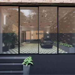 Viewed from the outside through large glass panels, this render shows the entire entrance lobby. The design provides a clear view of the parking area, the Buddha statue, and the custom signage, creating a transparent and inviting feel.
