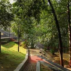 **Nepean Greens, Mumbai:** The plaza is nestled within a lush green environment, offering a tranquil escape in the heart of the city. The design integrates pathways and seating with existing trees and new plantings to create a harmonious public space.