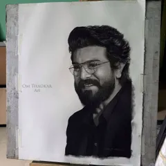 The full view of the Ramcharan portrait on the easel. This shows the completed artwork before framing, showcasing the fine pencil work on paper.