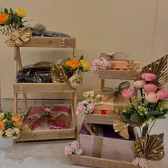 A collection of tiered wooden stands for trousseau display, decorated in different color palettes to match the wedding's theme.
