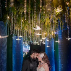 We love designing unique themes that tell your story. For this celestial sangeet, we created an enchanted pathway with hanging crystal birds and atmospheric lighting, making the couple's entrance feel like a walk through the stars.