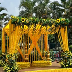 The Haldi ceremony is all about vibrant joy, and we love bringing that to life. Here, a classic mandap is transformed with bright yellow marigold garlands and fresh sunflowers for a sun-kissed, outdoor celebration.