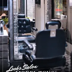 Our dedicated men's grooming section, featuring classic barber chairs and a sophisticated black-and-white aesthetic.