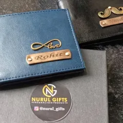 Two beautifully crafted personalized wallets, one in blue with an infinity 'Love' charm and the other in black with a mustache charm, both packed in my signature gift box.