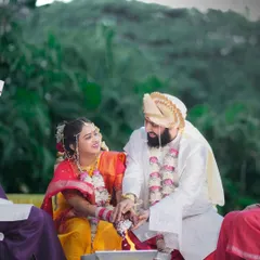 The couple participates in a traditional wedding ritual, sharing a smile. We are experts in documenting the sacred ceremonies of Maharashtrian weddings with care and precision.
