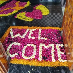 To create a grand entrance, I can design a custom welcome mat made from colorful flower petals. This is a simple but highly effective way to greet guests and add a touch of class to any event.