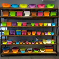 I stock a huge variety of lightweight and durable plastic planters. These shelves show just a fraction of the colors and shapes available, from bright neons to simple pastels, ensuring you'll find the perfect match for your decor.