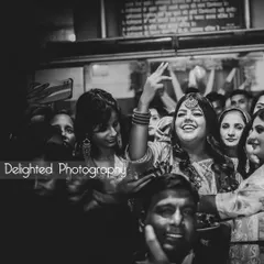 A candid black and white shot of a guest dancing and enjoying the celebration, capturing the lively and joyful atmosphere of the event.