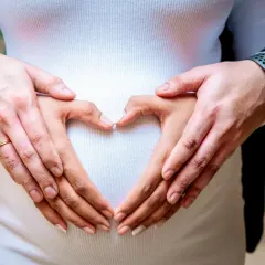 Together, their hands form a heart on the baby bump, a simple and powerful symbol of their shared love for the new life they've created.