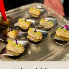 A tray of Lamb Adana Phyllo Cigars being served. These savory bites are inspired by Turkish flavors and are always a crowd-pleaser.