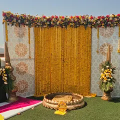 For a classic and traditional haldi function, we use beautiful marigold flower curtains and ornate brass urlis. This decor style honors tradition while still feeling elegant and picture perfect.