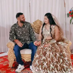 A beautiful couple at their engagement. The bride-to-be is wearing a custom brown lehenga with delicate white and mint green floral embroidery.