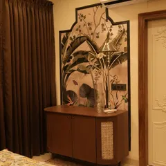 This image shows a custom-designed wooden console and a beautiful wall panel with tropical-themed art, framed in a traditional arch shape. The ornate white door adds to the classic charm.