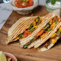 Our vegetable quesadillas are grilled to perfection, filled with cheese and crisp veggies, and served with fresh salsa, sour cream, and guacamole.