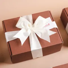 A close-up of the perfectly tied bow on a Wella gift box. We are meticulous about these details because they elevate the entire gifting experience.