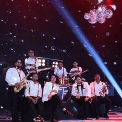 Meet the full squad. For bigger events that need that extra punch, we roll out our 10-piece band, complete with a horn section. This is the team that brings our massive sound and choreographed shows to life.