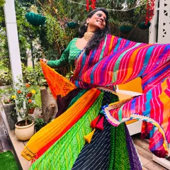 A candid shot from my Teej festival photoshoot. The vibrant, multi-colored lehenga is perfect for the festive and celebratory mood of Sawan.