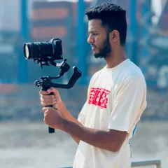 A side profile shot of me operating the camera on a gimbal. I am always focused on getting the perfect angle and composition for every shot.