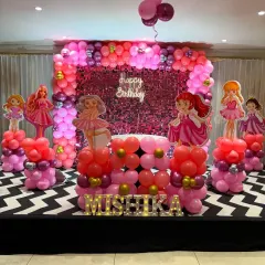 This Barbie and princess-themed stage is all about pink and sparkle. We used a sequin backdrop, themed balloon columns, and character cutouts to create a glamorous setting for the birthday girl, Mishika.