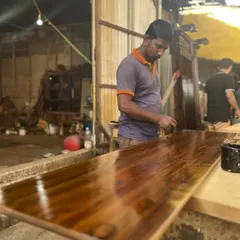 The final polish is a moment of pride. Our craftsmen take their time to bring out the natural beauty of the wood, ensuring a finish that is as durable as it is beautiful.