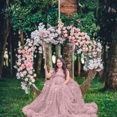 One of our most loved outdoor props is this beautiful floral swing. It creates a whimsical, romantic setting for a truly memorable maternity portrait.