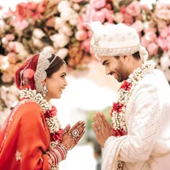 A respectful and loving greeting between the bride and groom during their wedding ceremony. This close-up shot highlights their traditional attire, intricate henna, and the deep connection in their eyes.