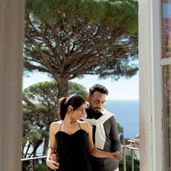 A quiet moment on a balcony overlooking the Italian coast. This frame captures the stylish elegance of the couple and the stunning sea view, embodying the essence of a luxurious European pre-wedding experience.