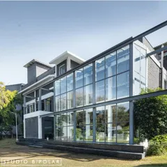 This shot showcases the new glass and steel structure we added to the main office building at Media Monks. The transparent facade was designed to maximize natural light and offer expansive views of the campus greenery.