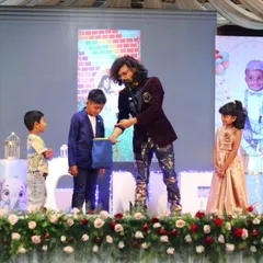 My magic shows are designed for the whole family. I love seeing the wonder on kids' faces as they become part of the magic on stage. This moment from a birthday party is a perfect example of the interactive, fun-filled experience I create.