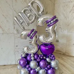 This custom balloon sculpture was for a 33rd birthday. I used silver and purple chrome balloons to create a modern and stylish arrangement that stands on its own.