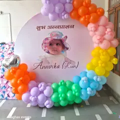Another view of the rainbow-themed Annaprashan decoration, showing the full circular balloon arrangement.