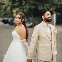 A classic walking pose with a modern twist. This shot captures the couple hand in hand, ready to step into their future together, perfect for a Goa wedding photoshoot.