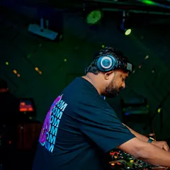 A side view of me at the console during a high-energy set. Every beat and drop is carefully chosen to build a story and keep the dance floor engaged.