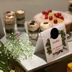 A close-up of our tiramisu dessert cups at an event for "Evolve". This showcases our ability to provide themed and branded dessert options for corporate clients.