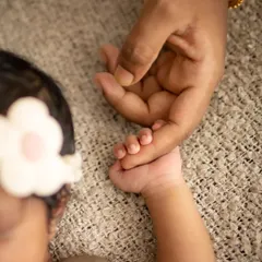 Little fingers wrapped around a parent's hand. These are the moments that show the immense love and gentle connection.