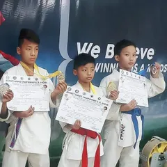 The future of Indian karate is bright. These three young students proudly display their medals and certificates after their success at the District Karate Championship. Their journey has just begun.