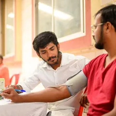 Here, a member of my team is checking a participant's blood pressure at our health camp. We provide comprehensive check-ups to give a complete picture of an individual's health.