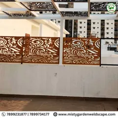 A close-up of the installed CNC privacy screen. The floral-inspired pattern adds an element of artistry to the functional barrier.