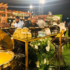 A guest enjoying a meal at our Mutton Mandi station. This candid shot captures the pleasure and satisfaction that our food brings to people.