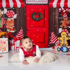 A curious baby looking up in wonder at our colorful and sweet candy shop backdrop.