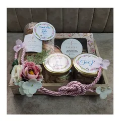 A special return hamper to celebrate 25 years of love. This elegant wooden tray hamper was filled with our assorted chocolates, cookies, and dry fruit jars, all customized with personalized tags for the silver anniversary.