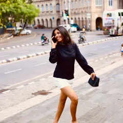 Even in a 'Femme Fatale' shoot, there's always room for fun. This candid shot of me breaking character on the phone shows the lighthearted, real moments that happen behind the scenes of every serious project.