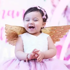 Look at that pure, unfiltered joy! We believe the best photos happen when kids are just being themselves. This is from a first birthday party, and this little angel's laugh made our day.