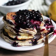 A stack of my protein-rich, sugar-free blueberry pancakes. I use alternatives like almond flour and natural sweeteners to make this a healthy breakfast that fits into a clean eating or sugar-conscious diet plan.