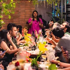 A full house at our Wine and Pizza Night. Our long community table is filled with guests enjoying food, wine, and great conversation, guided by a wine expert.