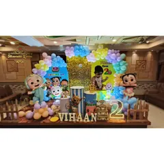 Here is another take on the Cocomelon theme, featuring a custom backdrop, themed plinths, and a picket fence prop. The child's name is spelled out in marquee letters, making it a personalized photo corner.