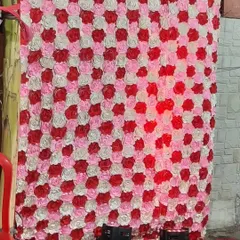 Another view of the artificial rose flower wall, showing how it looks with uplighting. I can provide lights to enhance the backdrop.