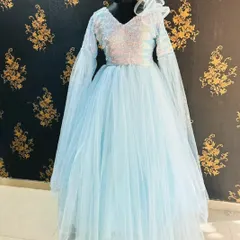 This sky blue ball gown features long, flowing bell sleeves and a sequined bodice. It's a unique and ethereal rental piece, perfect for a fantasy-themed photoshoot.