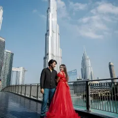Our rental gowns are perfect for destination photoshoots. This couple chose a bold red ruffled dress for their session in Dubai, standing out against the iconic city skyline.